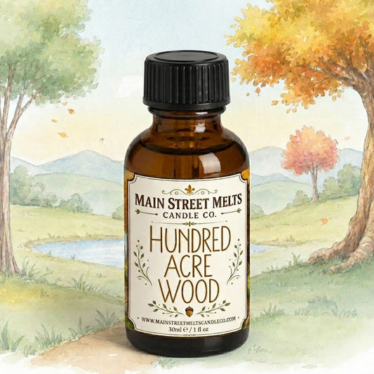 Bottle of 'Hundred Acre Wood' candle oil with a scenic background